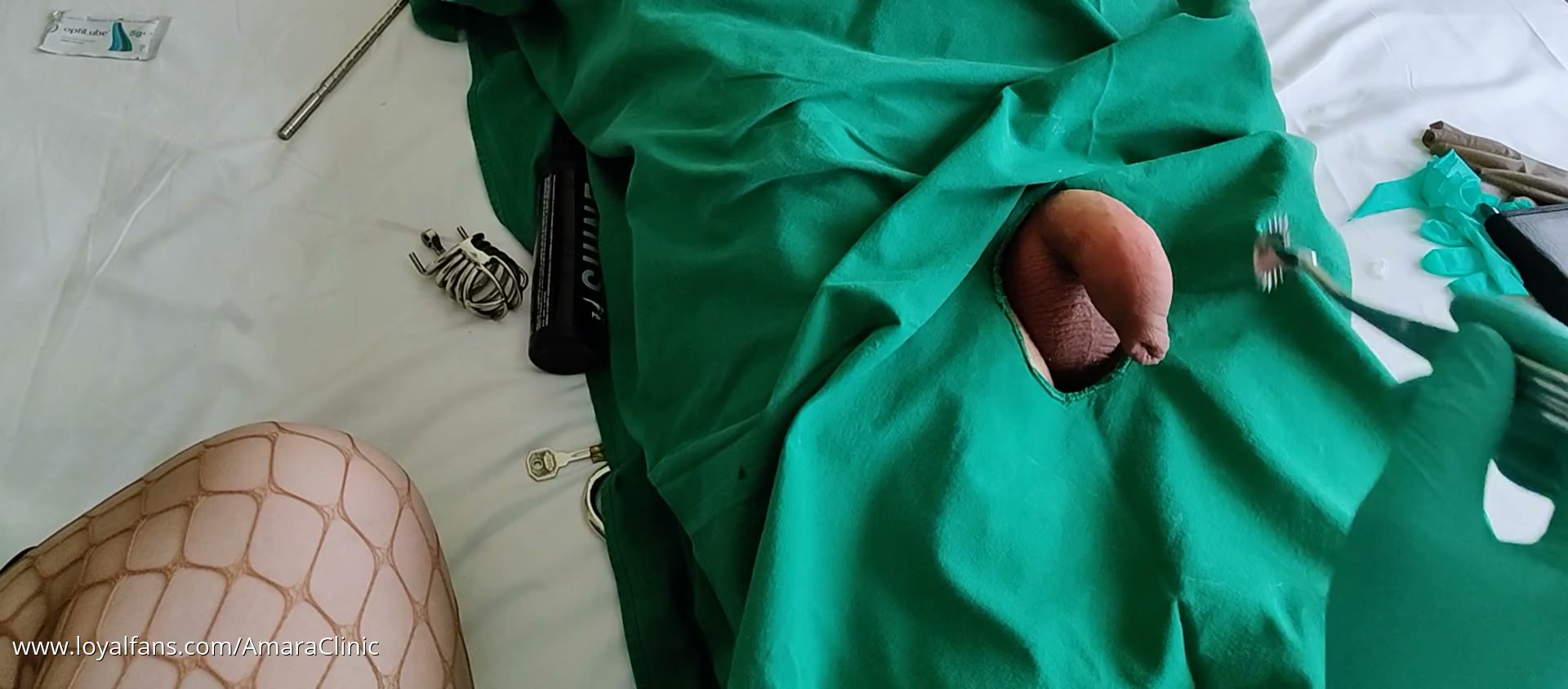 Mistress Katharina Amara playing in the travel clinic in her free MedFet hotel session video, gloved hands at the Amara Fetish Clinic